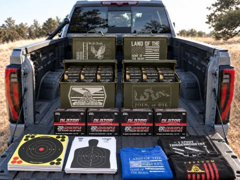 Engraved ammo cans loaded with 9mm, .22 LR boxes, targets and shirts on a truck tailgate