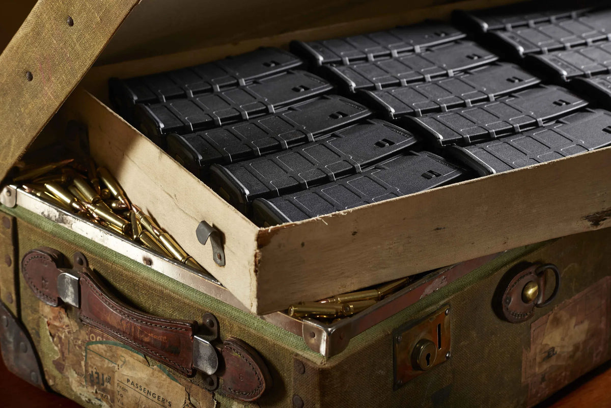 Loaded rifle magazines packed into a wooden crate