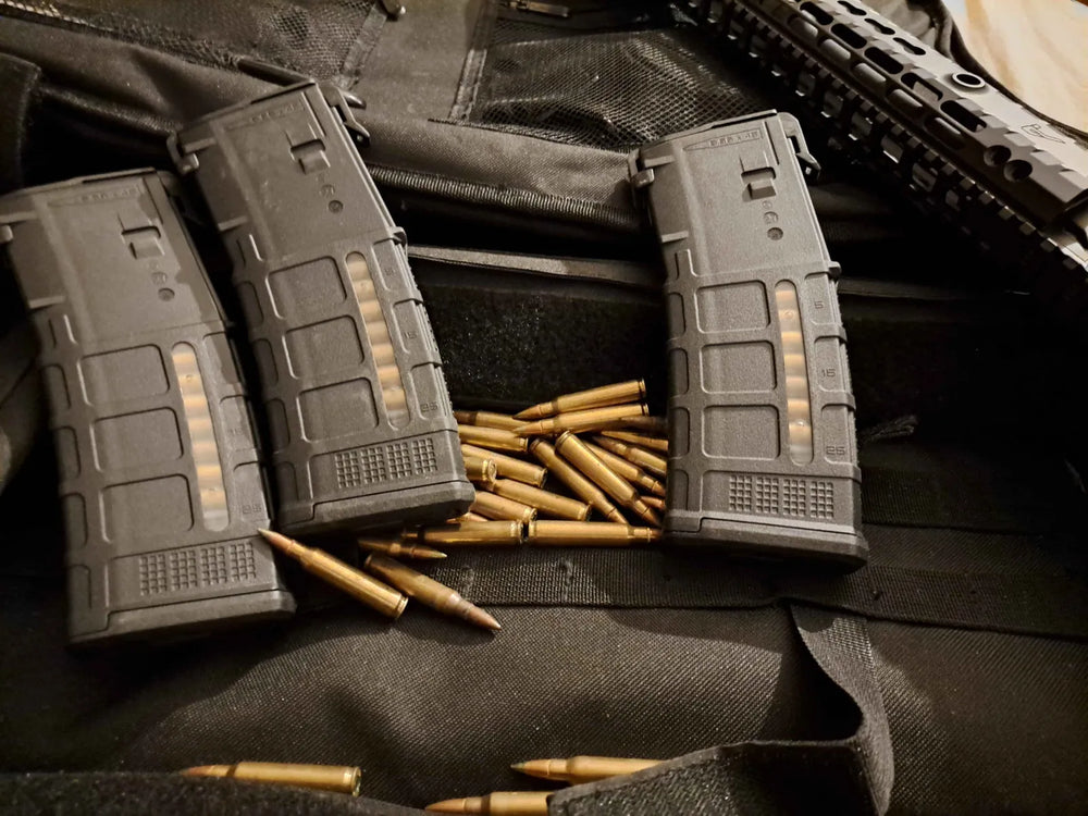 AR magazines and loose 5.56 rounds on a range bag