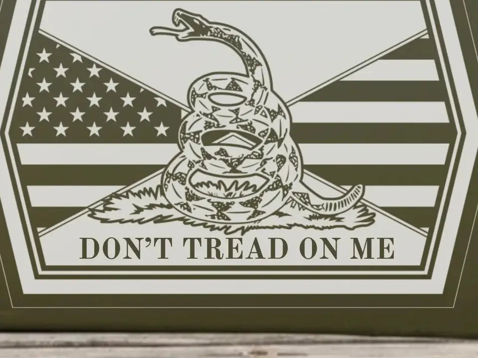Close-up of the engraved rattlesnake and DON'T TREAD ON ME on the can