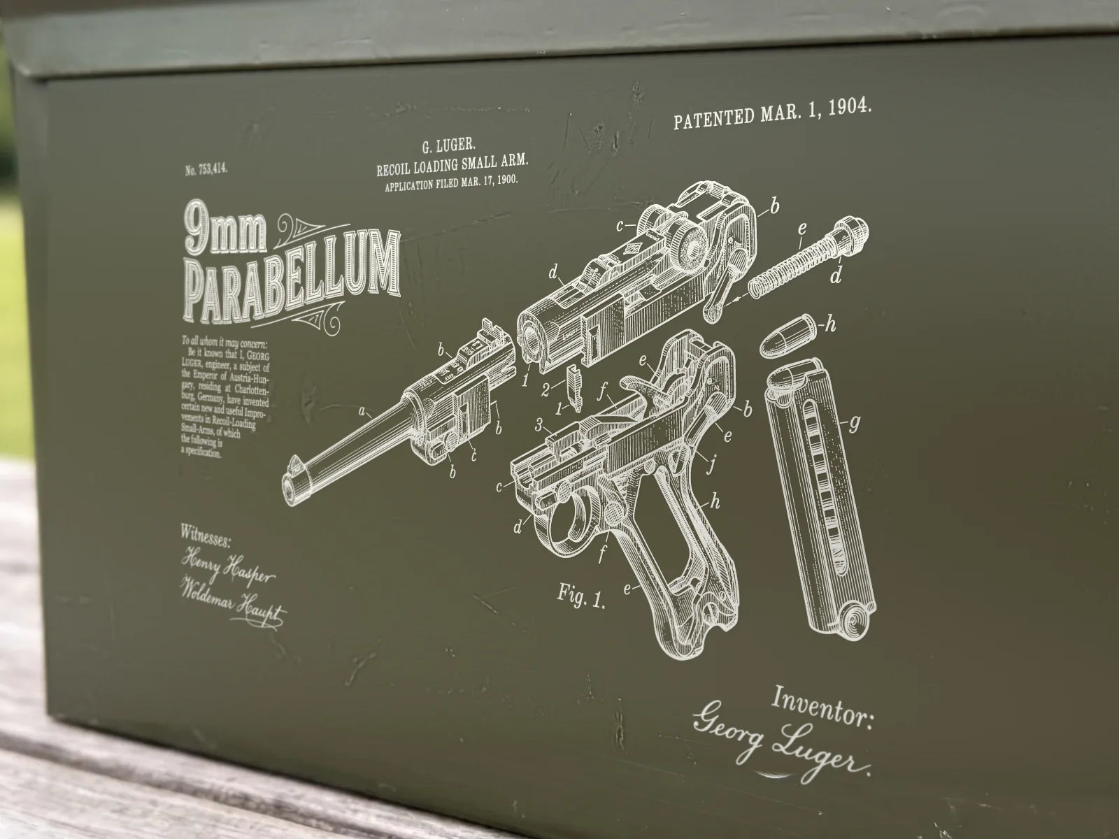 Close-up of the engraved 9mm PARABELLUM title and exploded pistol drawing on the can